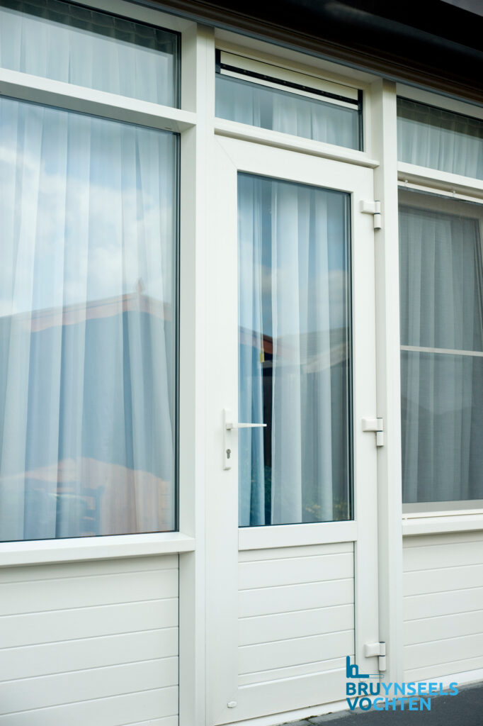 Witte Softline 82 NL retro deur met grote glaspartijen en sierlijke line-structuur onderaan, geplaatst door Bruynseels-Vochten.